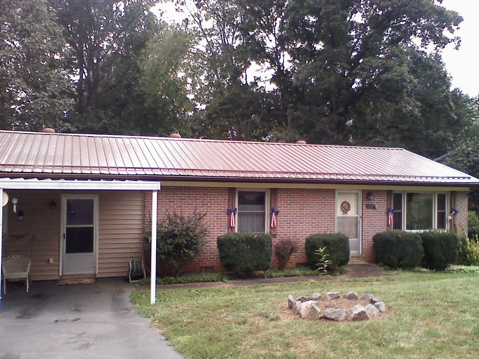 Bronze metal roof and carport on a brick ranch home — Roof Repair work by our crew in York
